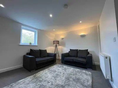 a living room with two couches and a window at Modern 2 BR Flat in Town Centre in Aberystwyth