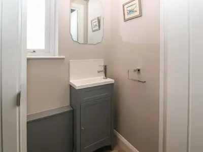a bathroom with a sink and a mirror at 1 Crud Y Mor in Barmouth
