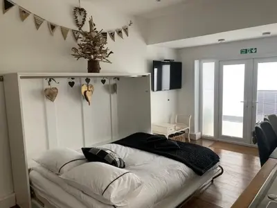 a bedroom with a bed in a room at Ty Cerrig seaside Annexe, New Quay in New Quay