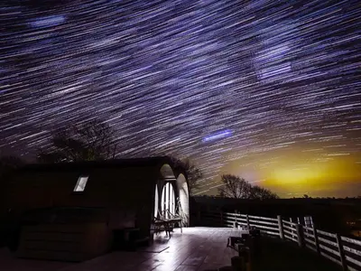 a starry night sky with millions of stars over a house at Ceunant in Aberystwyth