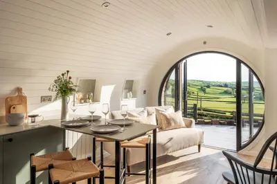 a living room with a table and a couch at Creuddyn in Aberystwyth