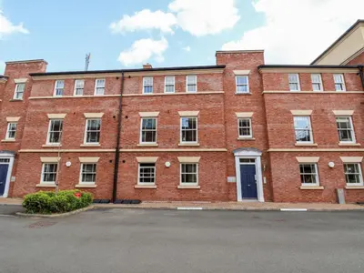 a large red brick building with a lot of windows at 122 The Old Meadow in Shrewsbury