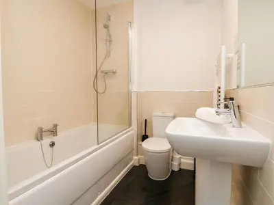 a bathroom with a sink and a toilet and a shower at 122 The Old Meadow in Shrewsbury
