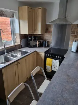 a kitchen with a sink and a stove at 41 mortimer drive, ideal location near ludlow in Orleton