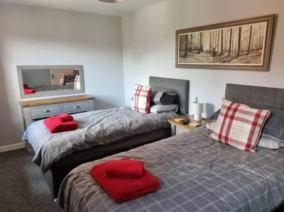 a bedroom with two beds with red pillows at 41 mortimer drive, ideal location near ludlow in Orleton