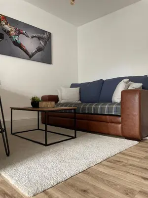 a living room with a couch and a table at Flat 1 in Lampeter
