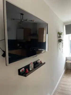 a mirror on the wall of a living room at Flat 1 in Lampeter
