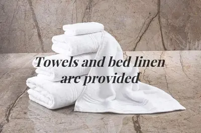 a pile of towels and bed linen are provided at Snowdonia Escape in Trawsfynydd