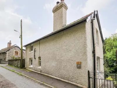 an old building with a chimney on the side of it at Myrtle Villa in Knighton