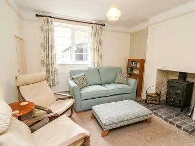 a living room with a couch and a fireplace at Myrtle Villa in Knighton