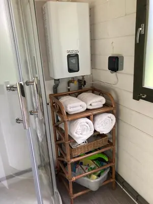 a bathroom with a towel rack with towels at Foxgloves and Fairytales Hut with Hot Tub in Llanwrda