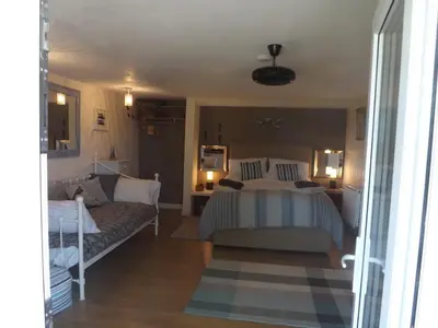 a bedroom with a bed and a couch at The Swallows Guest House in New Quay