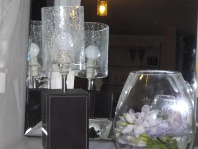 a table with glasses and a vase of flowers at The Swallows Guest House in New Quay