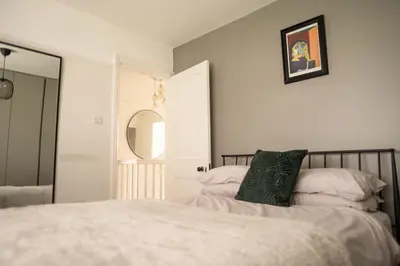 a bedroom with a bed and a mirror in it at Rose Hill in Shrewsbury