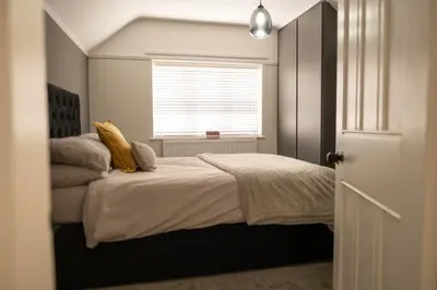 a bedroom with a large bed with a window at Rose Hill in Shrewsbury