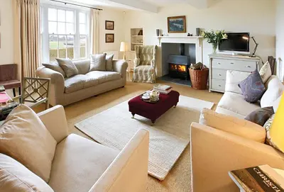 a living room with couches and a fire place at Upper Mowley in Kington