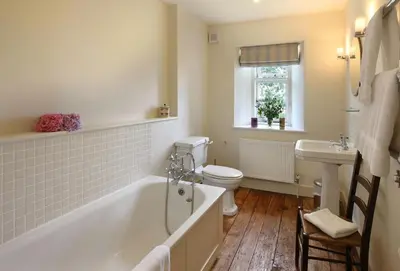 a bathroom with a tub and a toilet and a sink at Upper Mowley in Kington