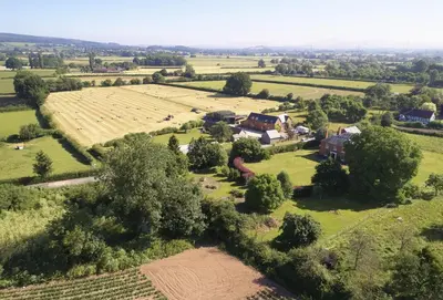 an aerial view of a farm with a large field at Pear Tree Cottage Shropshire in Orleton
