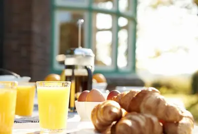 a table with a plate of breakfast foods and drinks at Green Gables in Eardisley