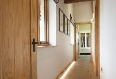 a hallway with a door and a window at The Cart Shed Shropshire in Downton
