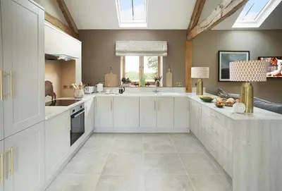 a kitchen with white cabinets and a sink at The Cart Shed Shropshire in Downton