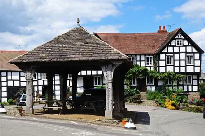an old black and white building with a gazebo at Stone House in Leominster