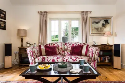 a living room with a couch and a table at Blacksmiths Cottage in Lingen