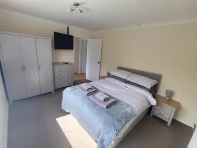 a bedroom with a bed with two towels on it at Y Nyth in Newtown