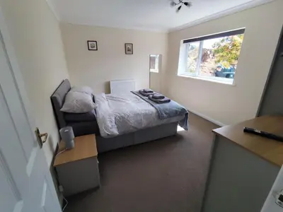 a small bedroom with a bed and a window at Y Nyth in Newtown