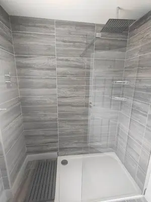 a bathroom with a shower with a glass door at Y Nyth in Newtown