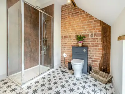 a bathroom with a shower and a toilet at The Dairy - Uk44130 in Baystonhill