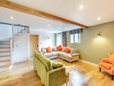 a living room with a couch and two chairs at The Stables - Uk44139 in Baystonhill