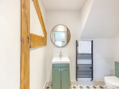 a bathroom with a green cabinet and a mirror at The Stables - Uk44139 in Baystonhill