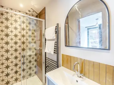 a bathroom with a shower and a sink and a mirror at The Stables - Uk44139 in Baystonhill