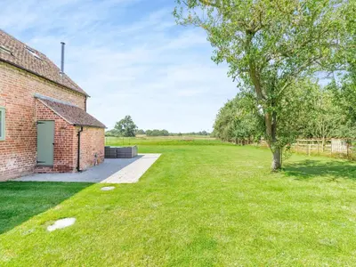 an empty yard next to a brick building with a tree at The Stables - Uk44139 in Baystonhill