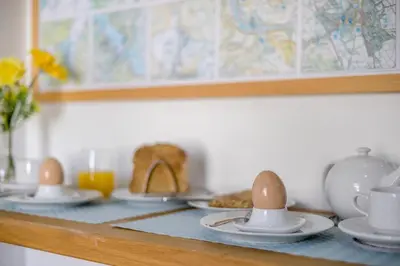 a table with eggs on plates and cups on it at 1 Bed in Cerrigydrudion oc-bow194 in Cerrig-y-Druidion