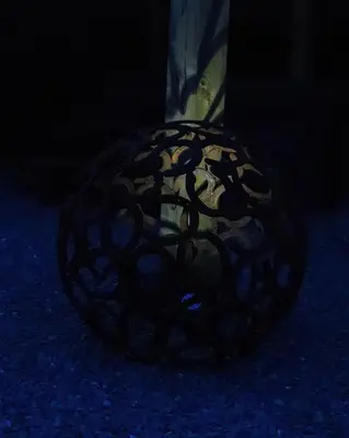 a black sphere sitting on the ground in the dark at The Shire Luxury Converted Horse Lorry with private hot tub Cyfie Farm in Llanfyllin