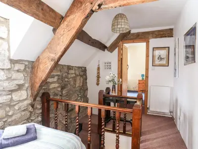 a room with a staircase and a stone wall at Gilfachwydd in Dolgellau