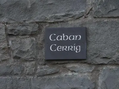 a sign on the side of a stone wall at Nature's Oasis: Pet-Friendly Snowdonia Cottage in Trawsfynydd