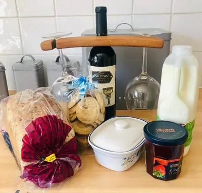 a counter top with a bottle of wine and some food at The Annexe at Walnut Tree Cottage in Hope under Dinmore