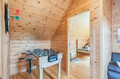 a sauna with a table in a wooden room at Robin Lodge in Llanbedr