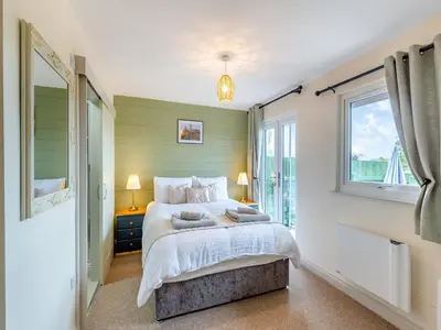 a bedroom with a large bed and a window at The Stables in Forden