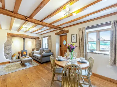 a living room with a table and chairs at The Cider House in Clee Saint Margaret