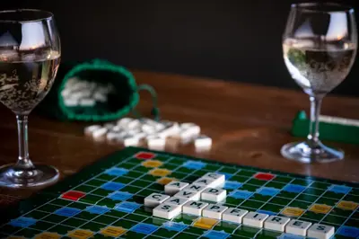 a chess board and two glasses of wine on a table at Canvas & Campfires, Luxury Safari Tent Glamping, only Seren Tent has a hot tub in Lampeter