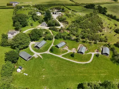 an aerial view of a farm with houses and trees at Canvas & Campfires, Luxury Safari Tent Glamping, only Seren Tent has a hot tub in Lampeter