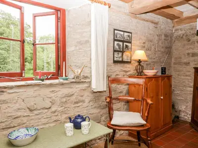 a room with a table and a chair and a window at Halls Mill in Kington