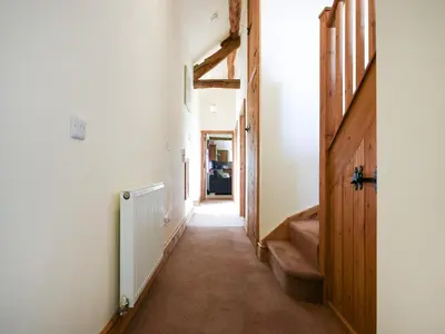 a hallway with a staircase and a hallwayngth at Y Dderwen in Pen-y-bont-fawr