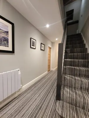 a staircase in a house with a carpet at Snowdon view, steam railway & Portmeirion nearby in Mynfford