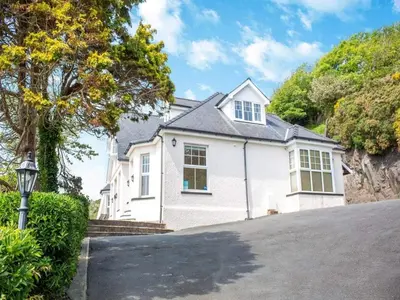 a white house with a driveway in front of it at Rockcliffe in Aberdyfi