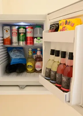 an open refrigerator filled with lots of drinks at The Mulberry Inn in Glyn-Ceiriog